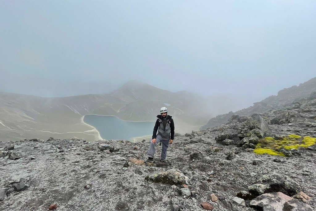 A hiker on the crater rim above the lagoon