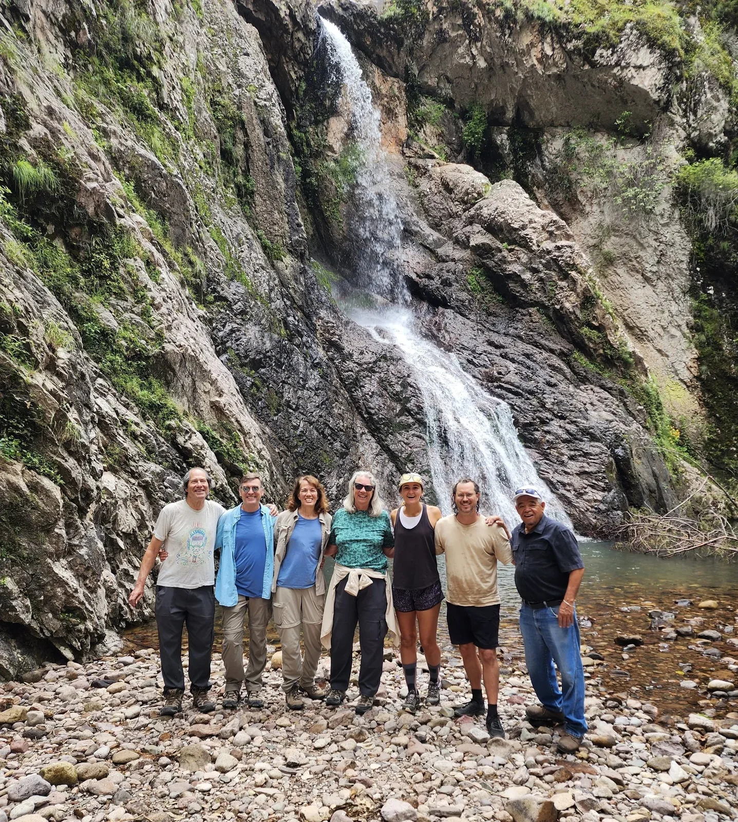 A hiking group beside a Sierra Tarahumara waterfall