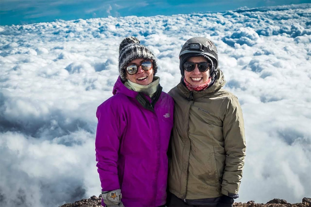 Hikers taking in the mountain views above the clouds