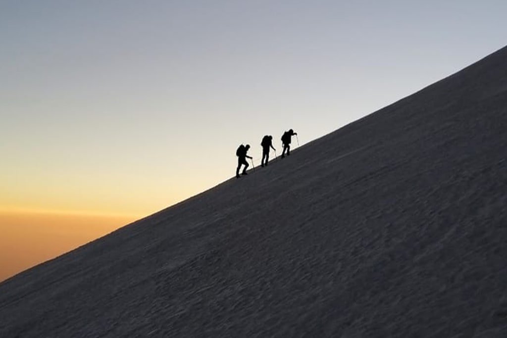 A rope team climbing Pico de Orizaba’s glacier at first light
